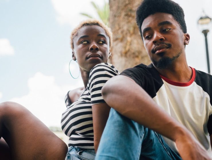 emotional infidelity - black couple sitting with back to each other
