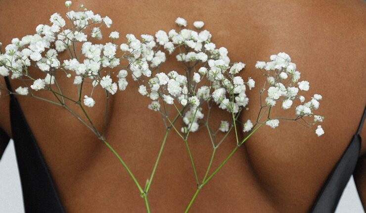 Black woman with flowers on her skin to find out about estrogen