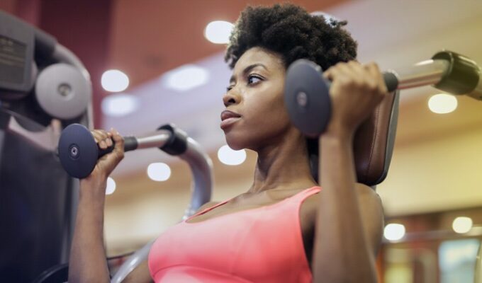 Black woman exercising to meet fitness goals
