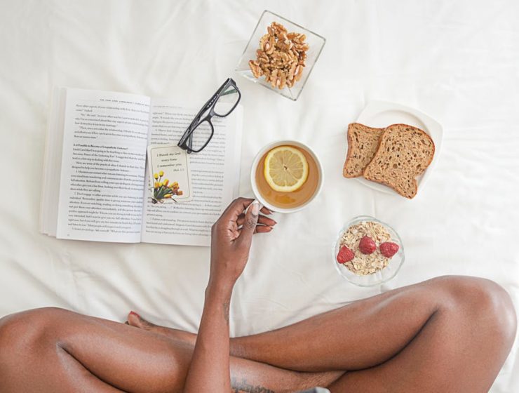 a-woman-eating-breakfast-and-reading
