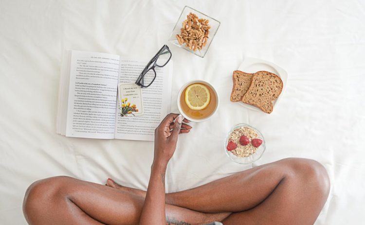 a-woman-eating-breakfast-and-reading