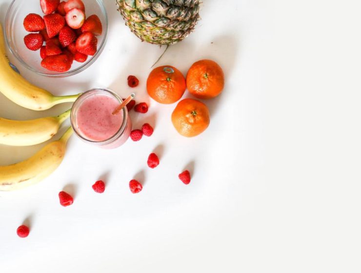 Display of bananas, strawberries, oranges and pineapple