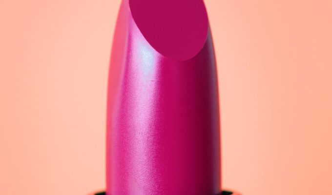 Red lipstick on plain background