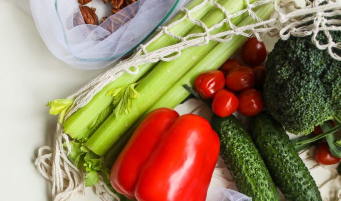 photo of red peppers, tomatoes and pickles beside broccoli