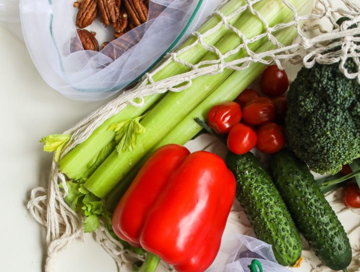 photo of red peppers, tomatoes and pickles beside broccoli