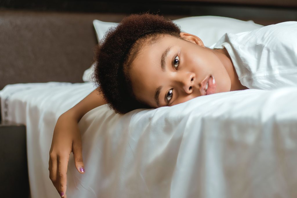 postpartum depression woman lying on a bed