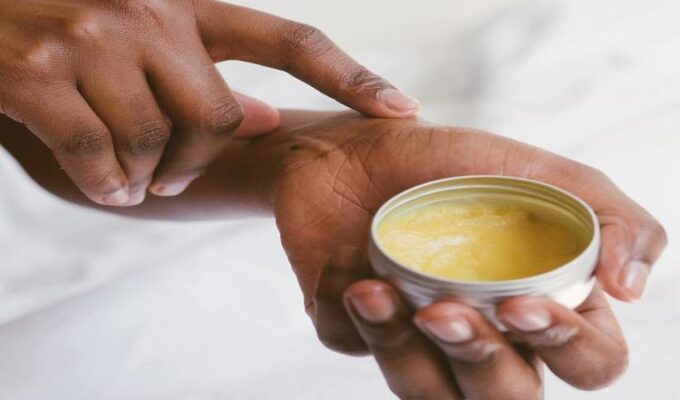 black-woman-applying-natural-oil-to-skin