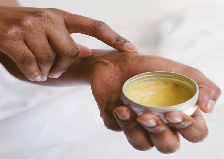 black-woman-applying-natural-oil-to-skin