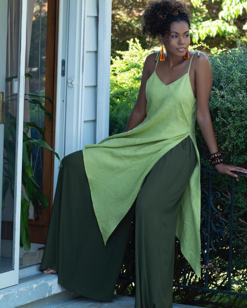 black woman wearing a green tunic and pants