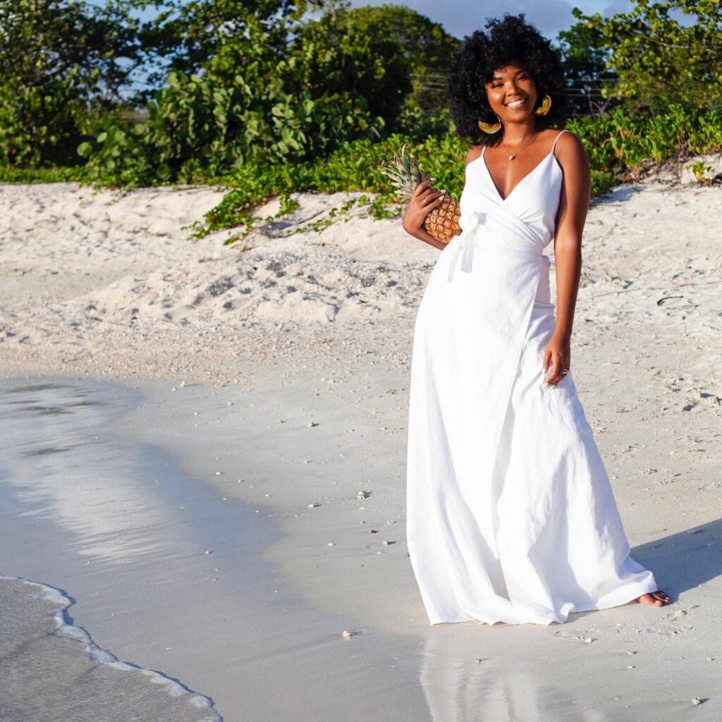 linen styles - woman wearing white linen dress at the beach