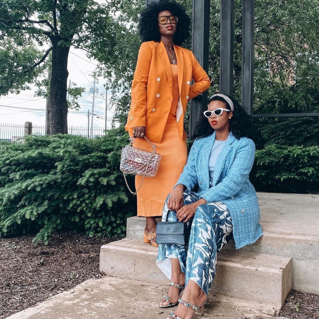 personal style - two stylish black women dress in blue and orange suits