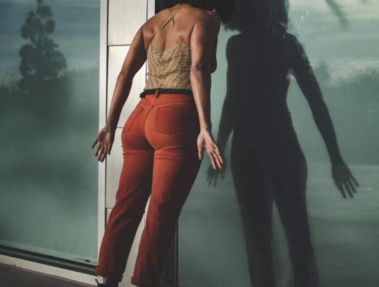 Stress remedy - black woman with head on glass wall