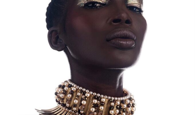 black woman wearing a spiky gold choker