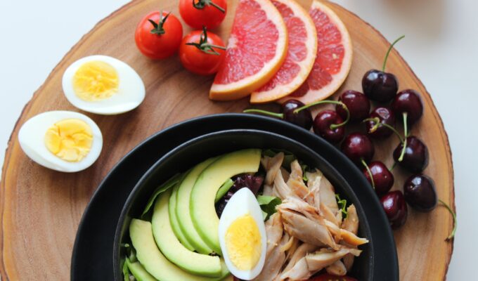 hormonal imbalance - plate of avocado, eggs, chicken and fruits
