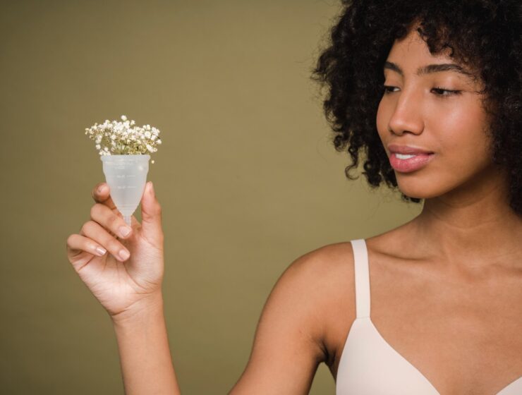 menstrual pain - A black woman holding a menstrual cup