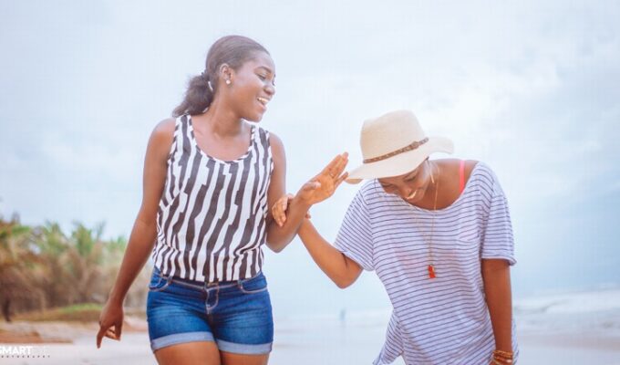 Two black women in friendship laughing together
