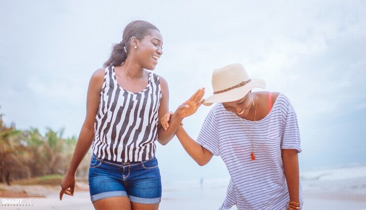 Two black women in friendship laughing together