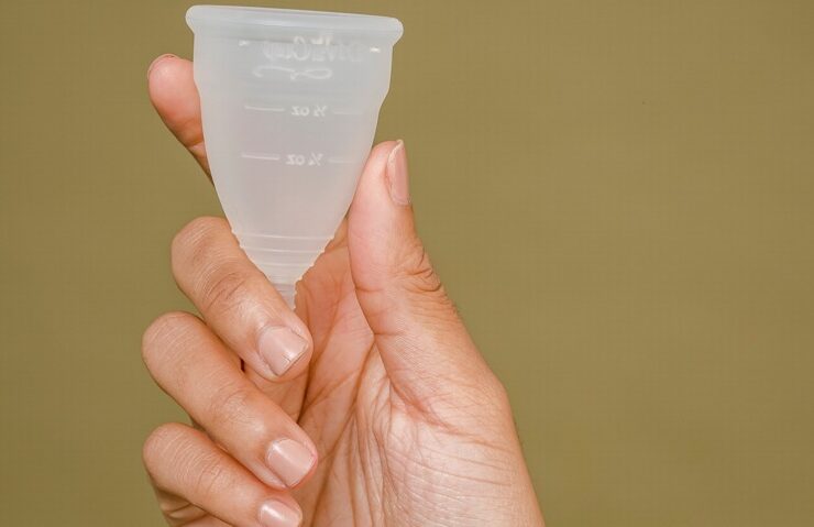 woman's hand demonstrating how menstrual cups are used