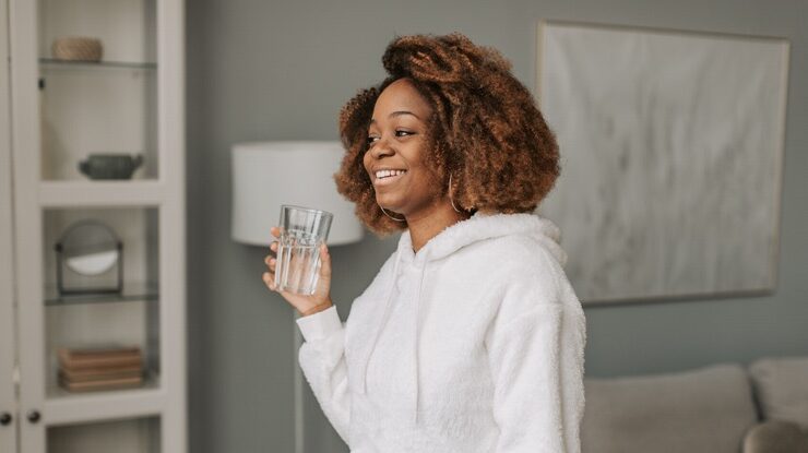 Black woman shows her morning routines starts with a glass of water