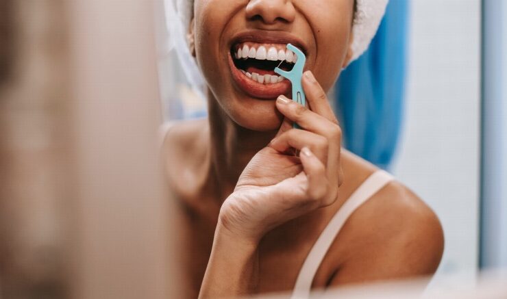 Woman practicing dental hygiene with a floss