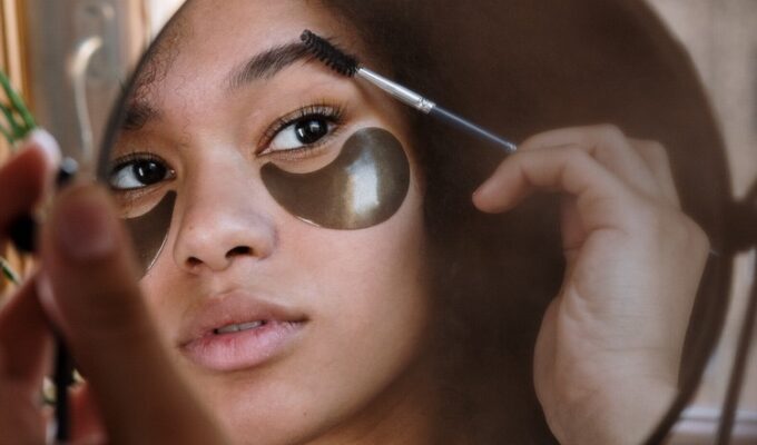 woman brushing her eyebrows