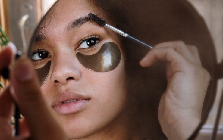 woman brushing her eyebrows