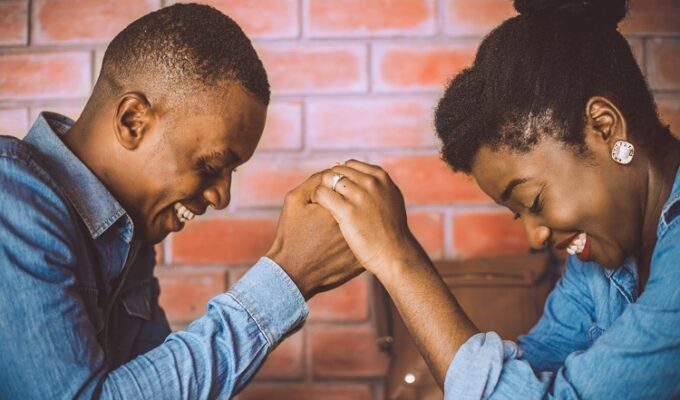 Black couple practicing romantic gestures