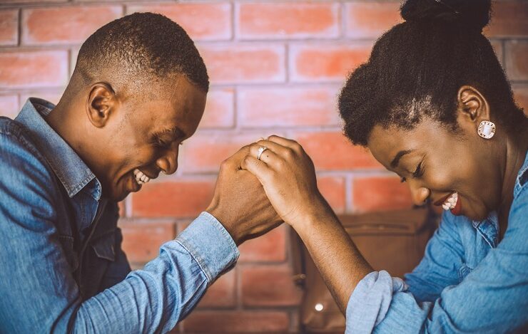 Black couple practicing romantic gestures