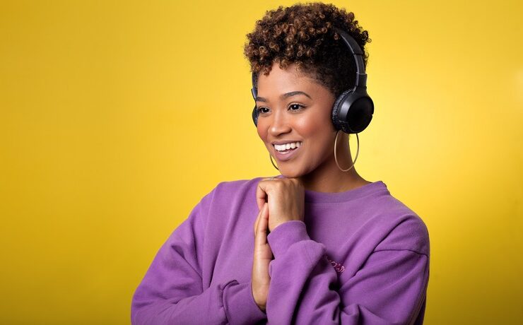 Black woman listening to inspiring podcasts