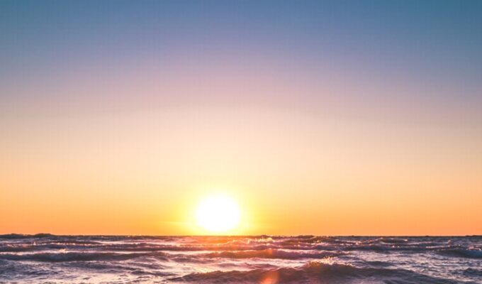 Sun rising over waters in a sign of spiritual journey