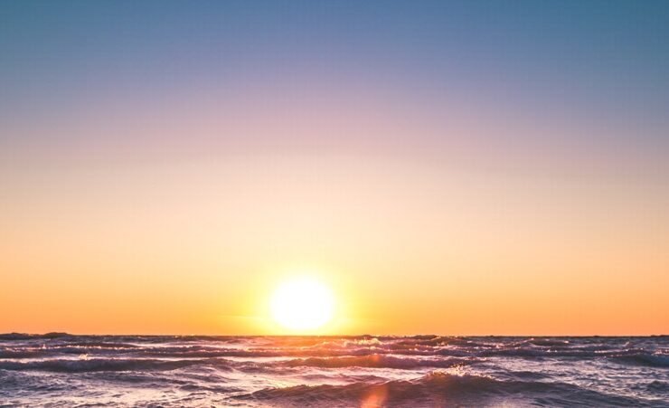 Sun rising over waters in a sign of spiritual journey