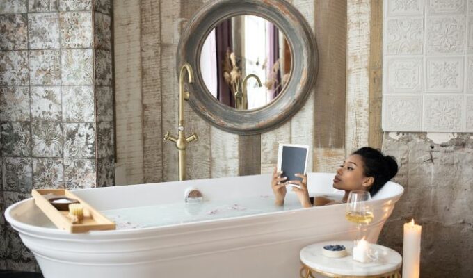 Black Woman Resting In Clean Bathroom
