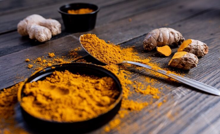 turmeric powder and fruit displayed on a table