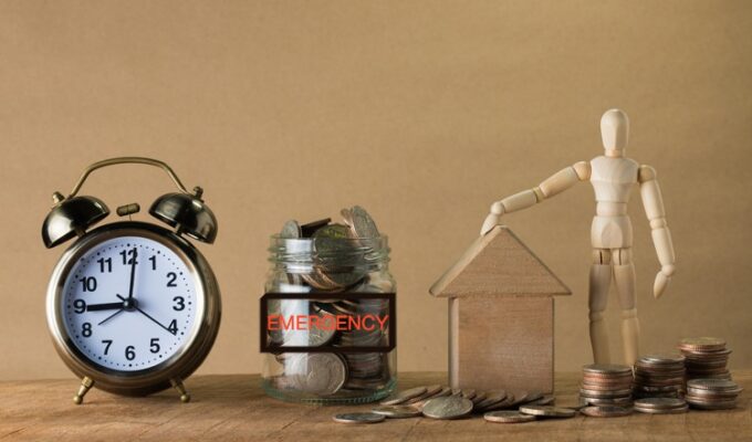 emergency funds demonstrated through a clock and coins in a bottle and on a surface