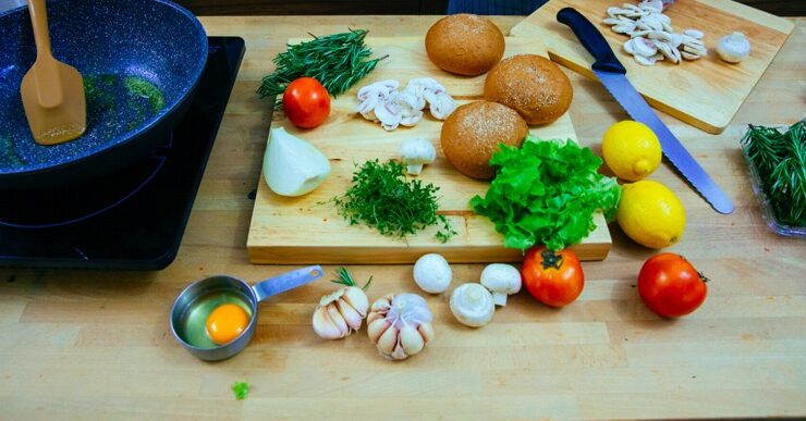 Potato salad ingredients, including lemon, garlic, onions, displayed on a table