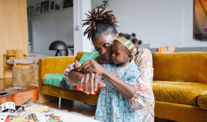 An African woman balancing motherhood and career while she plays with her child