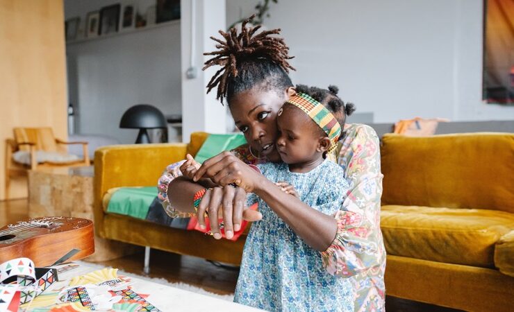 An African woman balancing motherhood and career while she plays with her child
