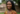 African woman with braids smiling on how to live healthy