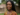 African woman with braids smiling on how to live healthy