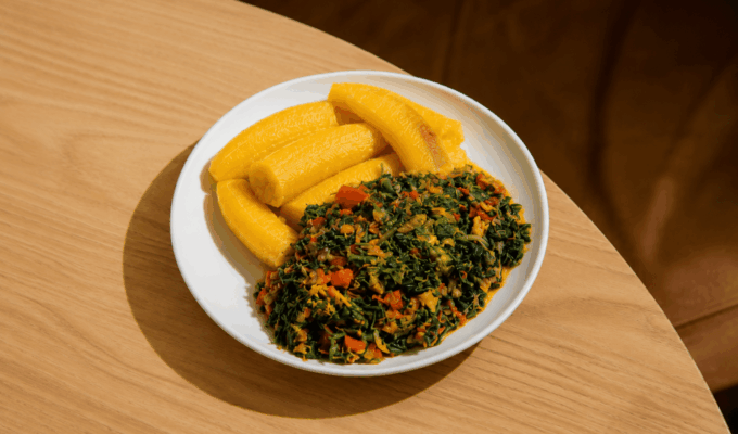 Plate of boiled unripe plantain and vegetable sauce showing an example of low-calorie African foods