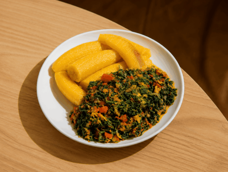 Plate of boiled unripe plantain and vegetable sauce showing an example of low-calorie African foods