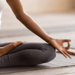 African woman practising meditation as part of emotional regulation