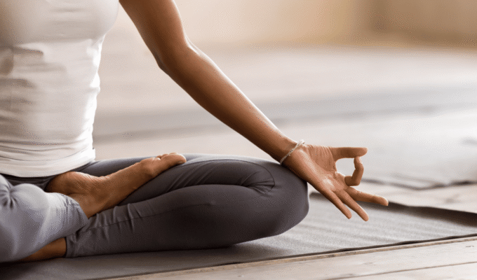 African woman practising meditation as part of emotional regulation