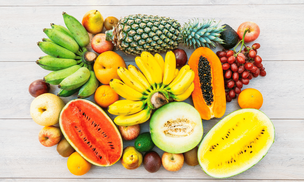 A colourful spread of African foods rich in vitamins and minerals, including bananas, pineapple, papaya, watermelon, oranges and grapes