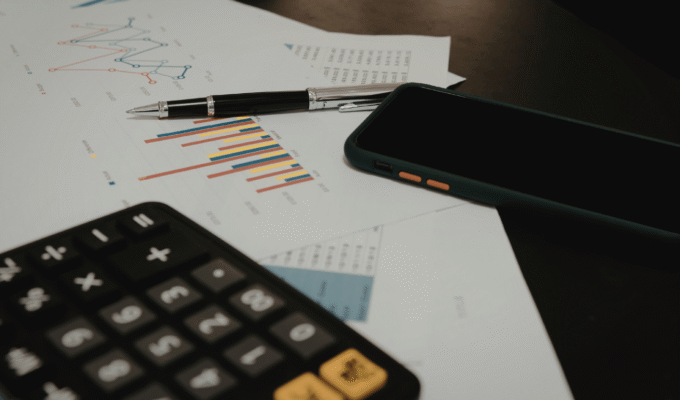 Person reviewing their finances while applying financial rules to know by 30