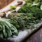 Fresh herbs for stress relief arranged on a wooden board