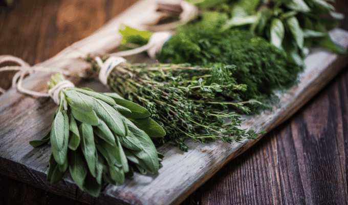 Fresh herbs for stress relief arranged on a wooden board