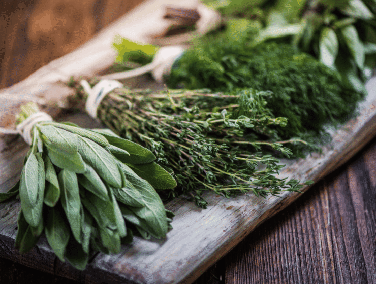 Fresh herbs for stress relief arranged on a wooden board