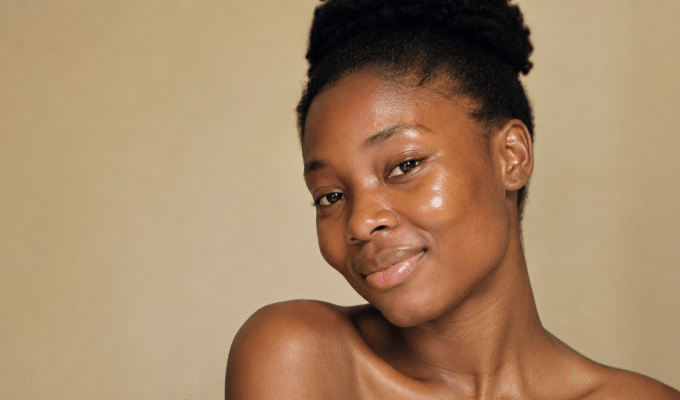 African woman with glowing natural skin, illustrating healthy skin and premature skin aging prevention